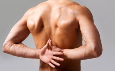 A man has back pain in the area below the shoulder blades